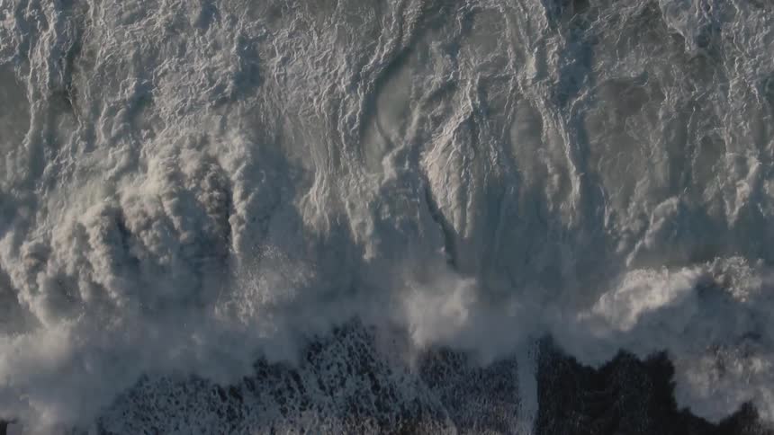 An aerial view of an ocean is displayed