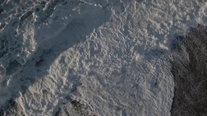 An aerial view of an ocean is displayed
