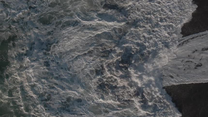 An aerial view of an ocean is displayed