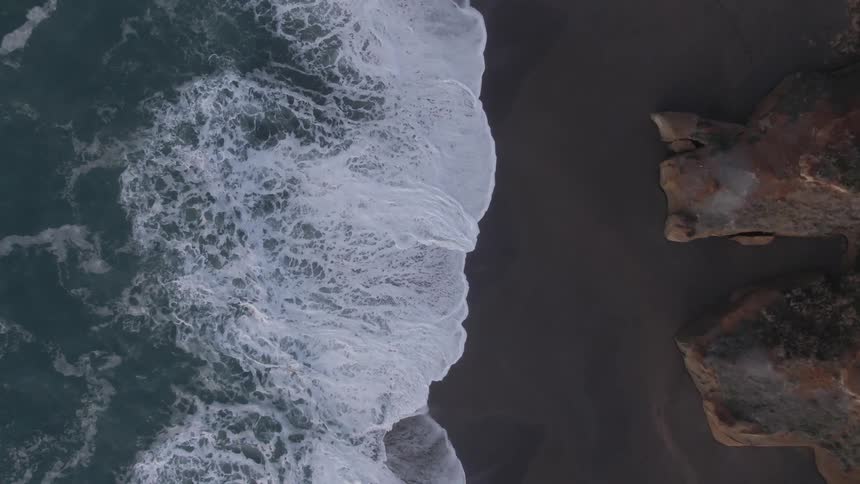 Birds eye view of waves rolling in to the shore