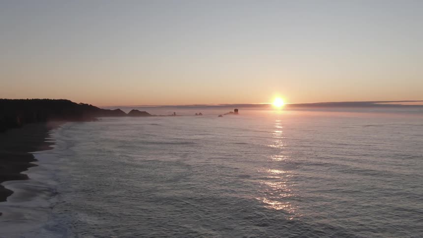 Aerial view of the sea and coast at sunset