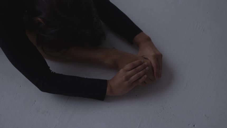 A woman is stretching on the floor