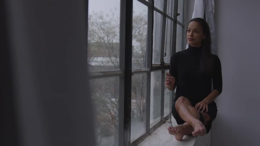 A woman in sitting by the window