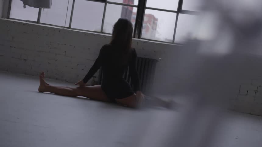 A woman doing the splits at home