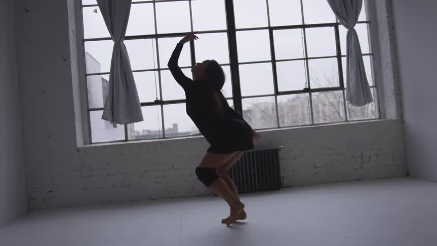 A young woman dancing at home