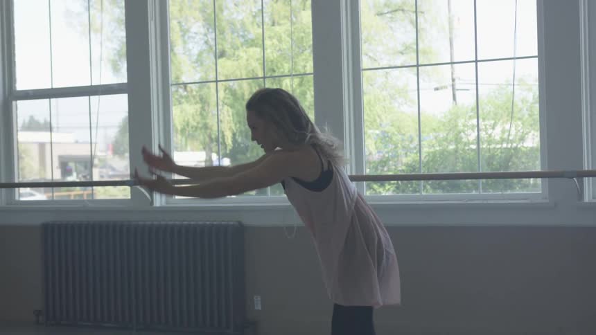 A woman is dancing in a building