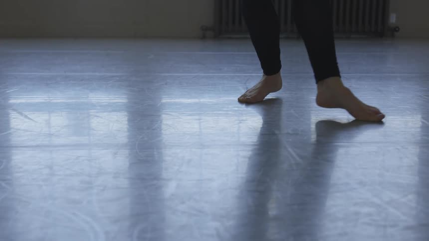 A woman is dancing in an empty room