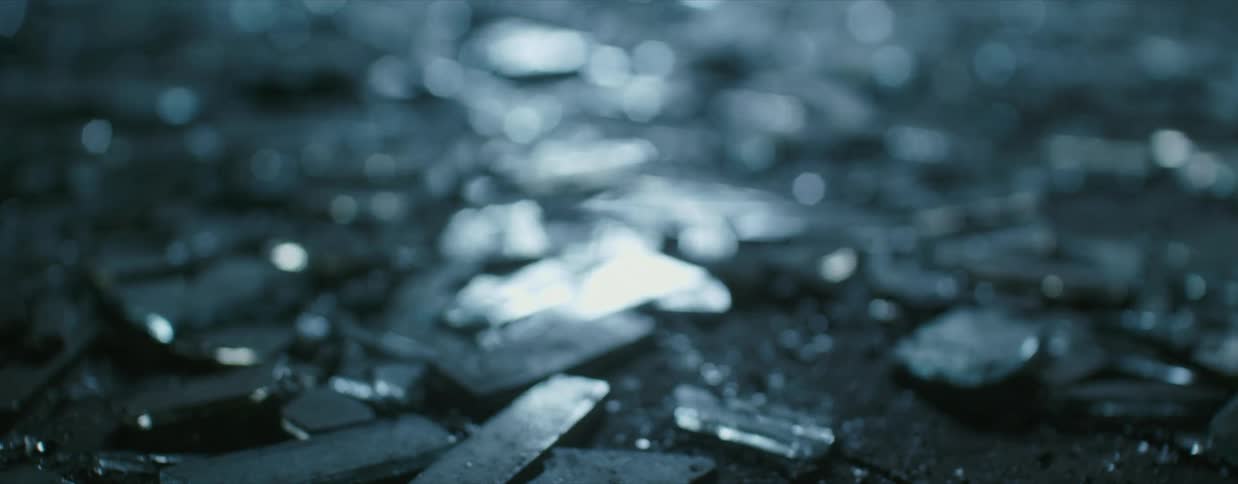 Shards of broken glass cover the ground