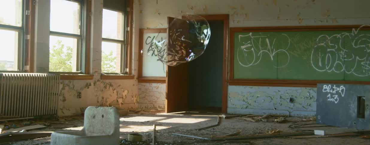 A bubble bursting in a room with graffiti
