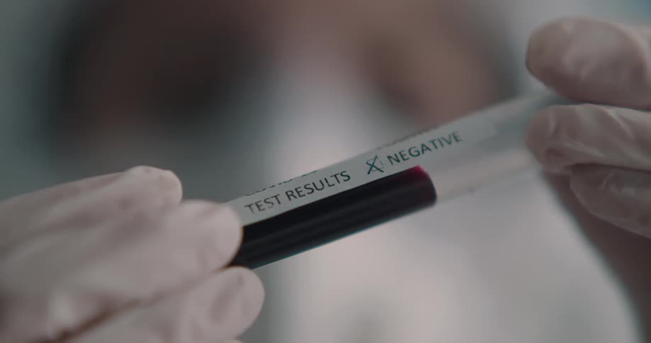Lab technician holds a test tube with a blood sample