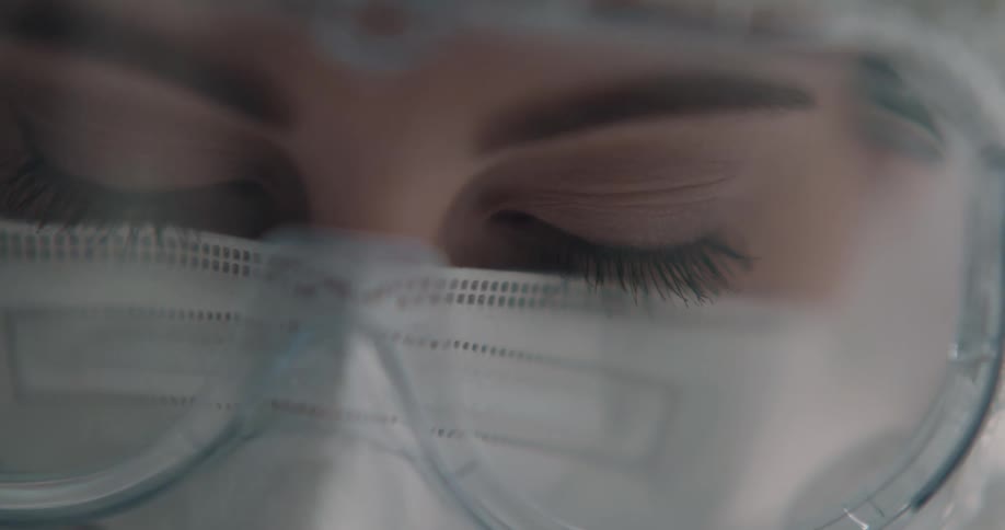 Woman wears goggles face mask and head covering