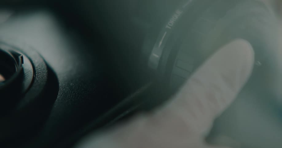 Thumb on focus knob of microscope