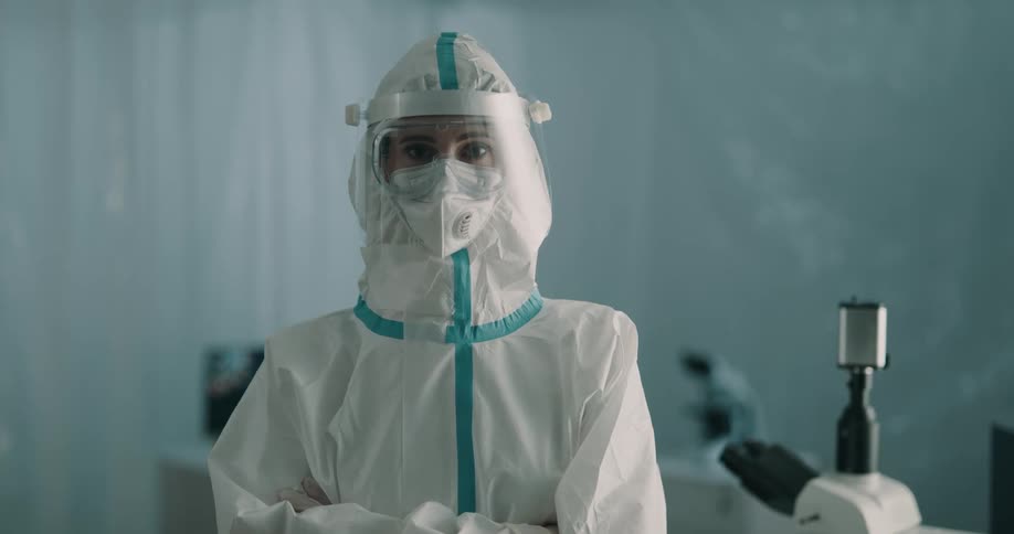 Healthcare worker in full ppe stands in lab