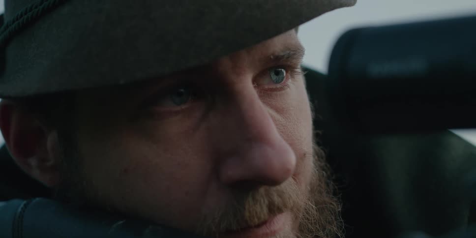 A man looks through the end of a barrel