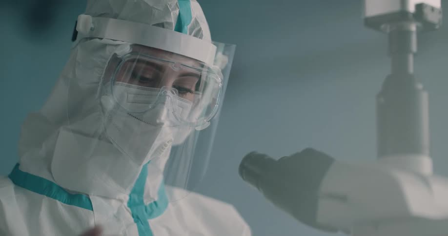 A female scientist writes on a vile of a blood sample
