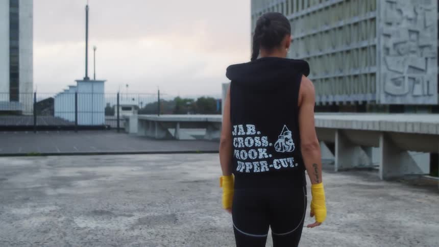 A woman is walking on the roof of an urban city