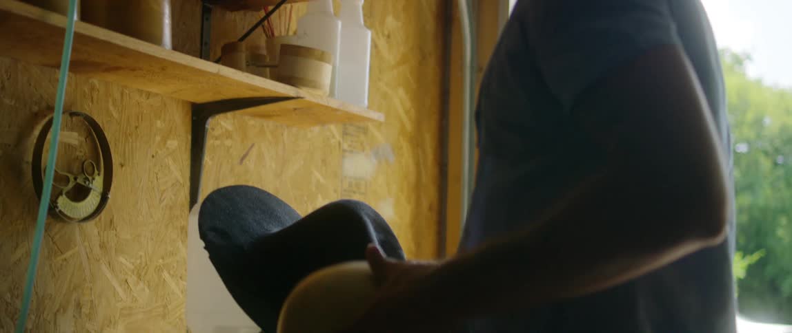Man searching on the shelves inside a garage