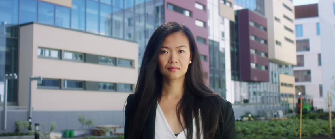 Woman standing outside of modern office building