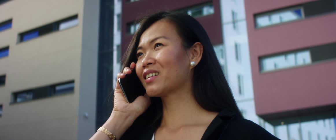 A woman is talking on a cellphone in a downtown city