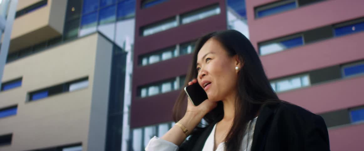 A woman is talking on a cellphone in a city