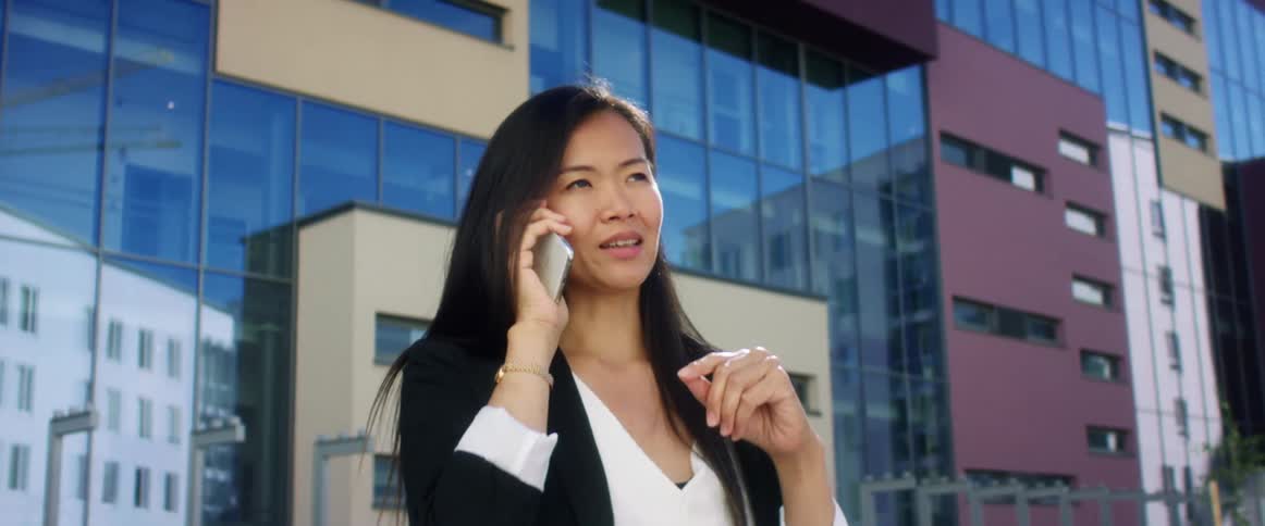 A woman is talking on a smart phone