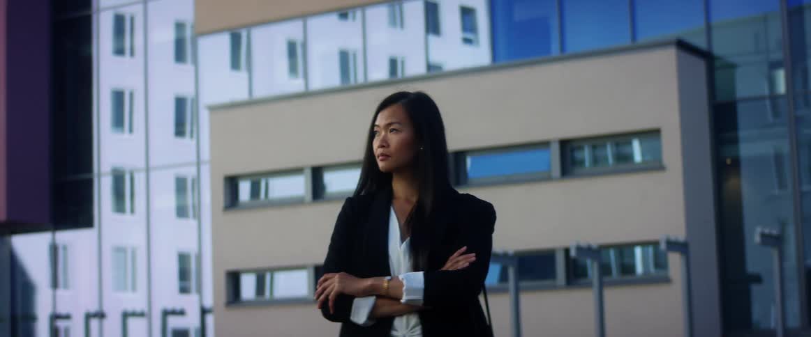 A woman is standing in a downtown city