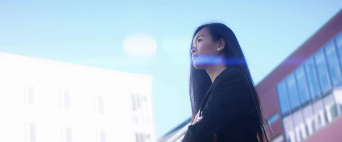 A woman is standing in a downtown city