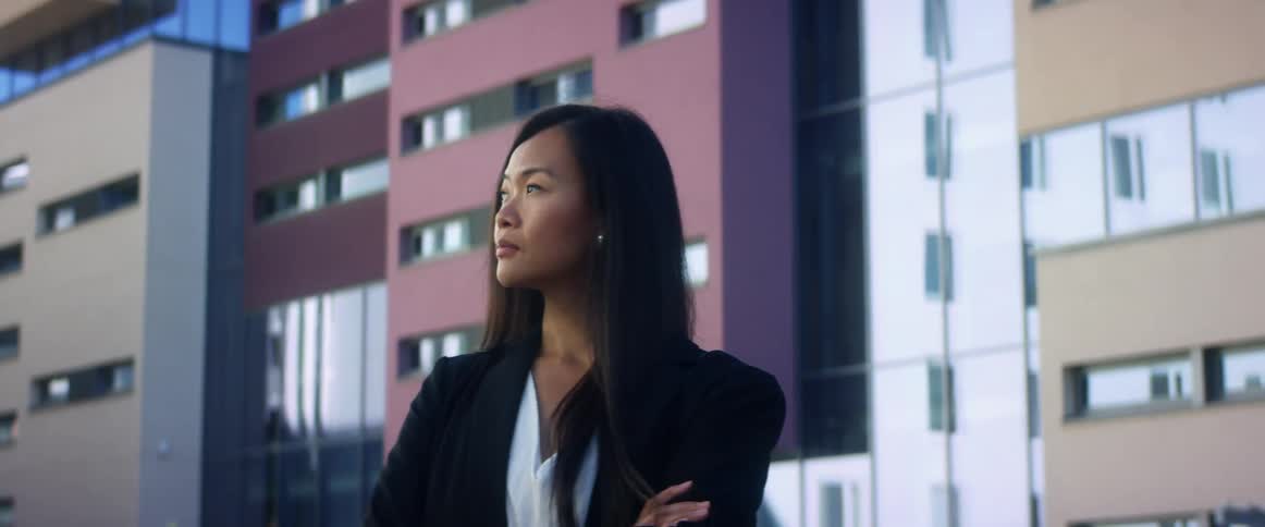 A woman is standing in a downtown city