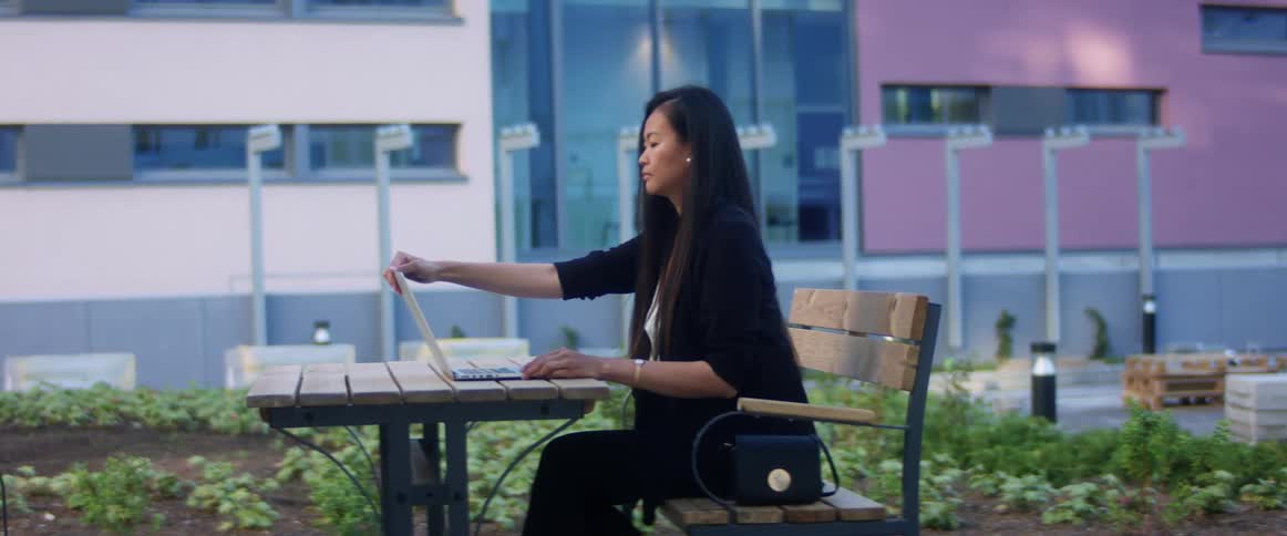 A woman stands up after using her laptop