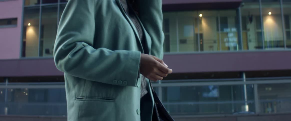 A woman is walking in a downtown city