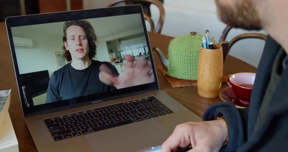 Two people talk on video conference