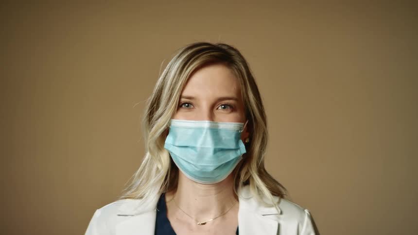 A woman is wearing a face mask indoors