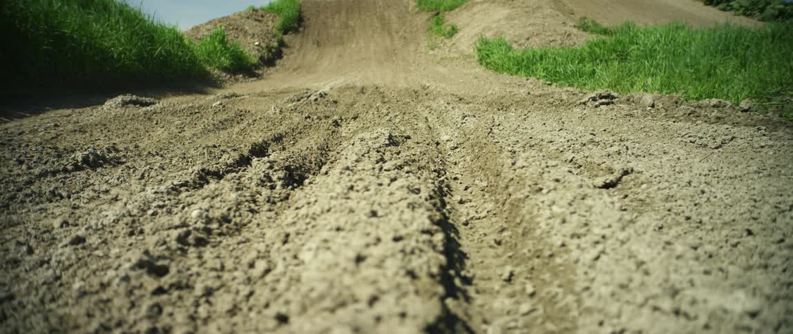 Bicycle tracks on a dirt gravel road at day
