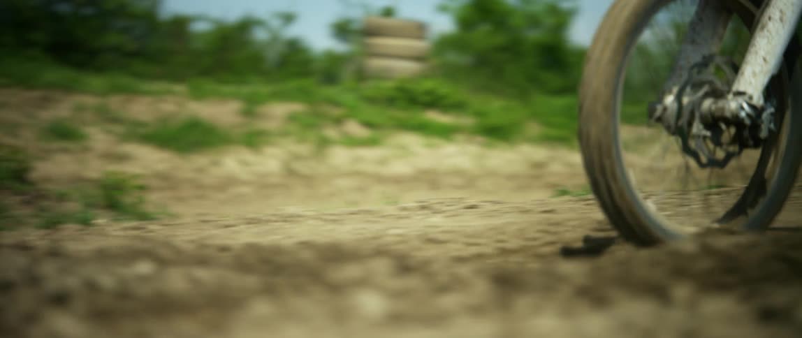 A person driving a motocross bike down a hill