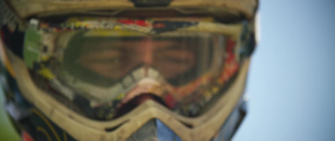 A man looks up wearing a crash helmet