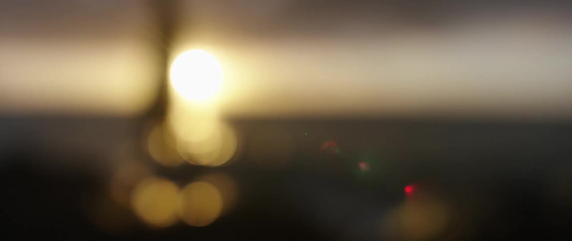 The sun is rising in the blurry view