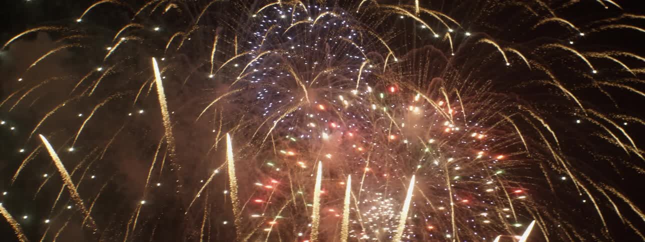 A fireworks display outside at night