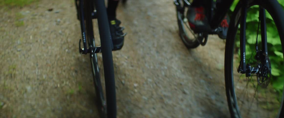 Two people are riding bikes outdoors in spring