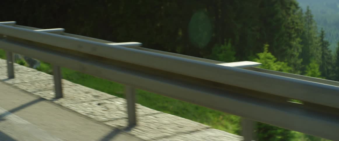 Traveling next to the guardrail on a road in the mountains