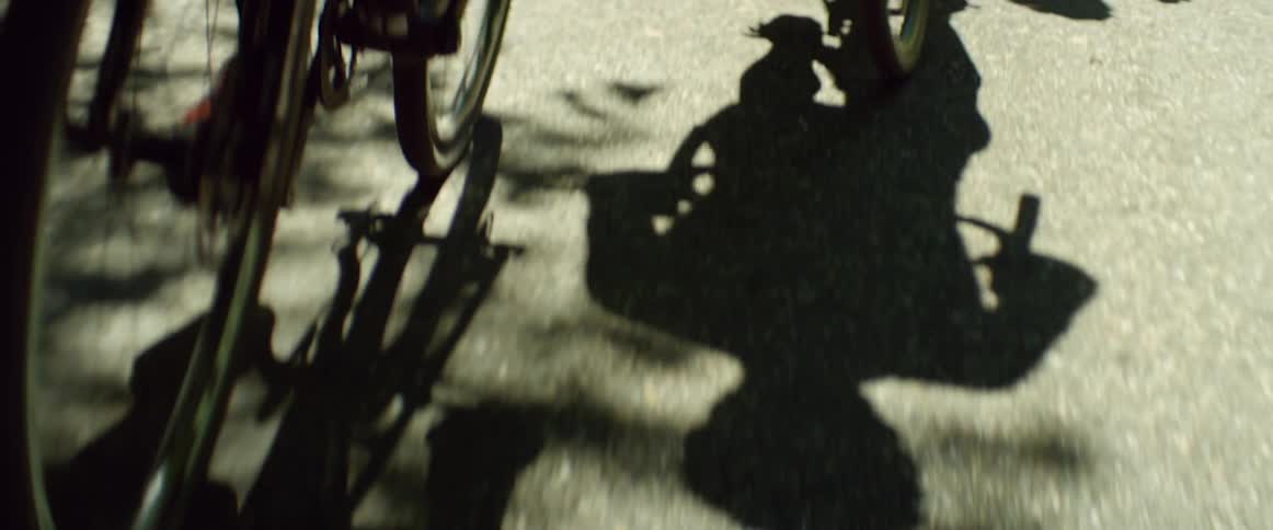 Two men are riding bikes during the day