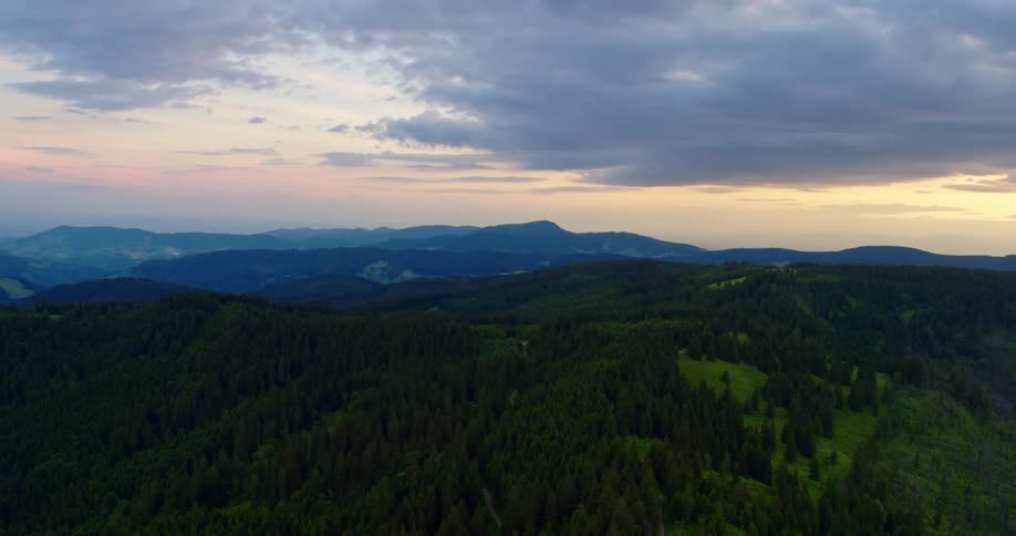 Clouds floating above a mountain forest landscape in the summer