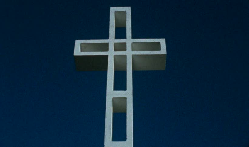 Strobing lights shining on a white cross
