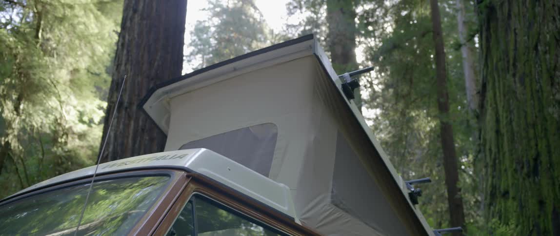 Close up of a container on top of a vehicle by the woods