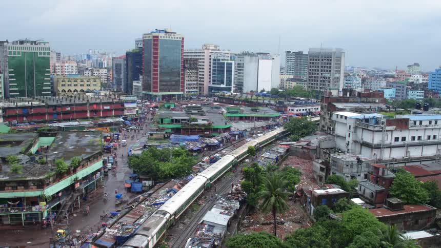 Aerial view of a train going through an primitive city