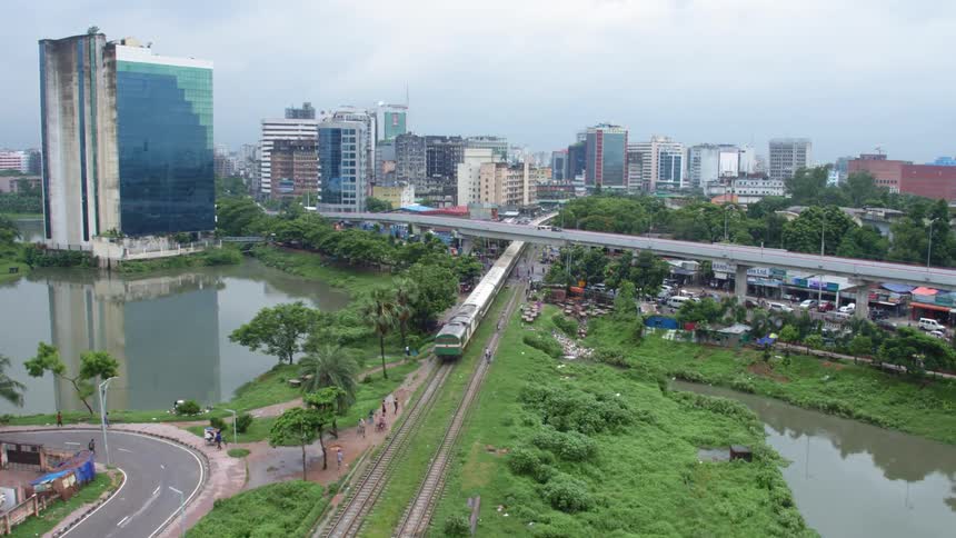 Aerial view of a train driving into a city over lakes