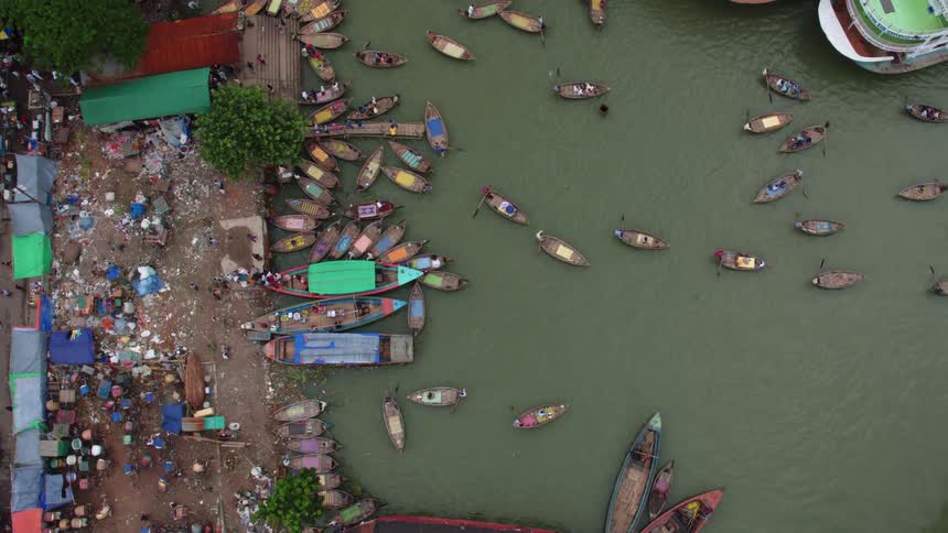 Birds eye view of people in boats in the water and walking on the boardwalk
