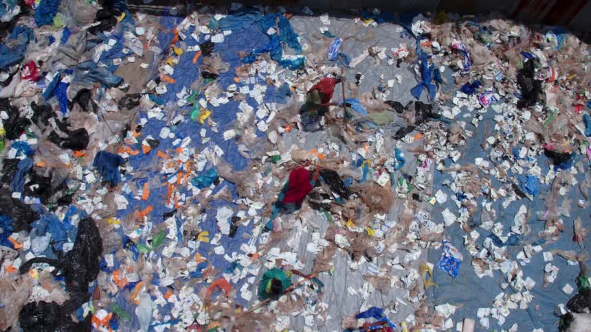 Group of people going through garbage in a third world country