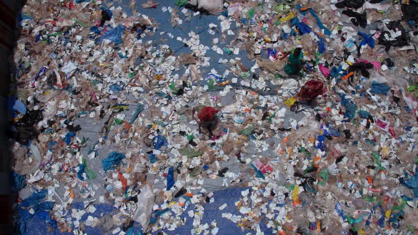 Group of people working on a landfill in a third world country slum