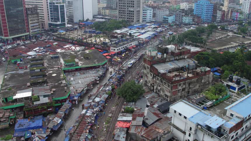 A city with building trees roads and vehicles