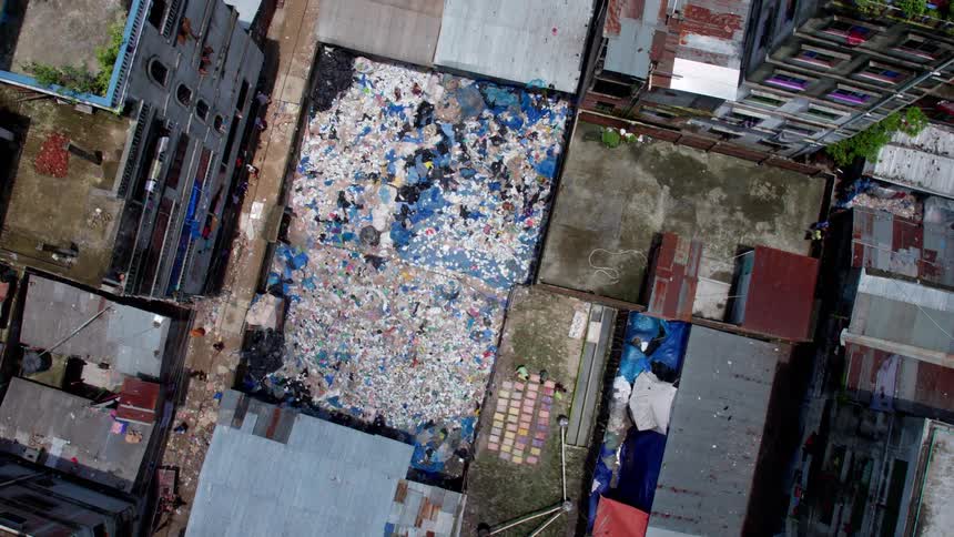 Birds eye view of slums and a dump with heaps of trash